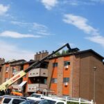 A picture of an apartment roof repair by Performance Construction.