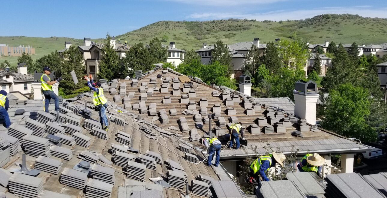 A picture of Performance Construction installing a roof for an apartment complex.